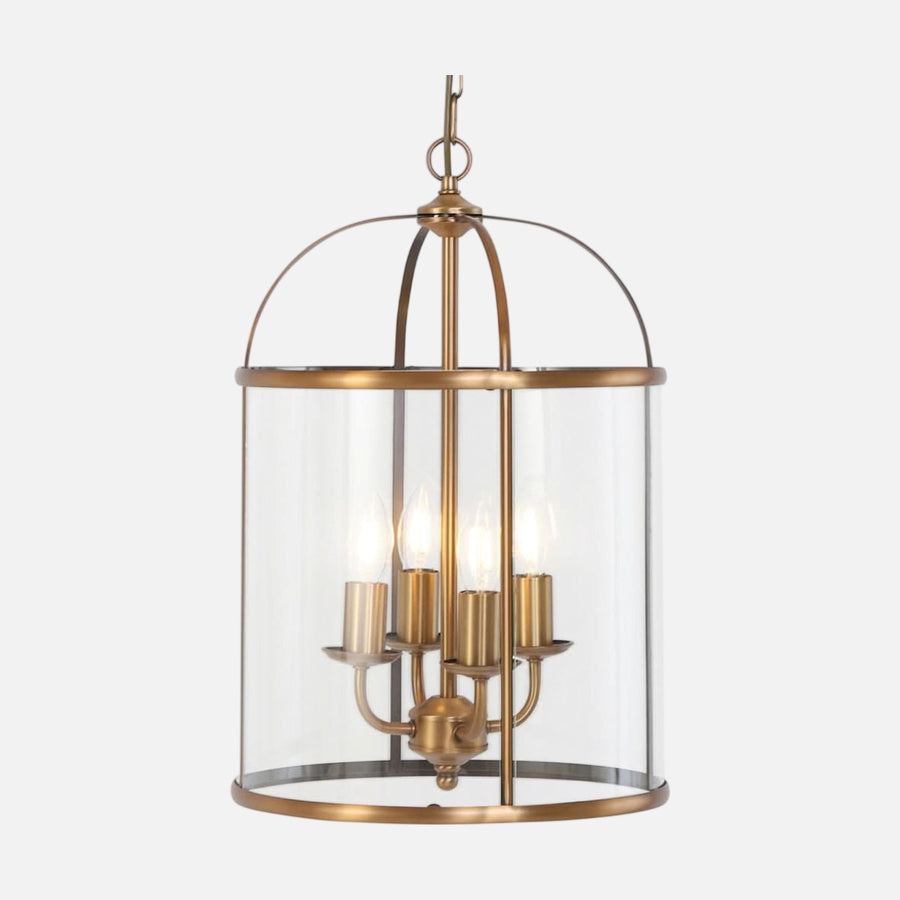 Vue de face du luminaire suspendu en bronze avec cage en verre cylindrique et quatre lumières