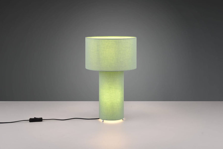 Vue rapprochée de la lampe cylindrique allumée, socle diffusant une lumière chaude