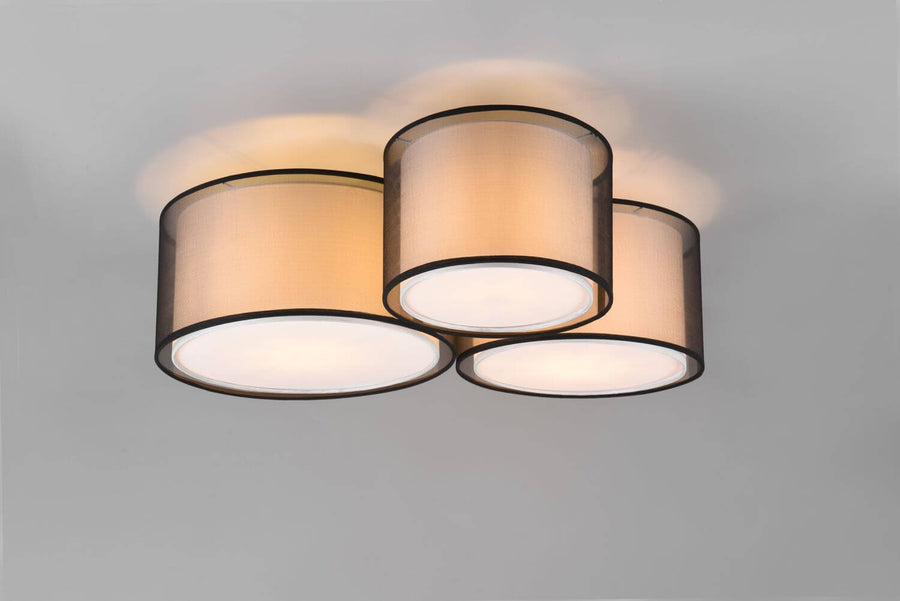 Produit de face sur fond gris, trois abat-jours cylindriques allumés