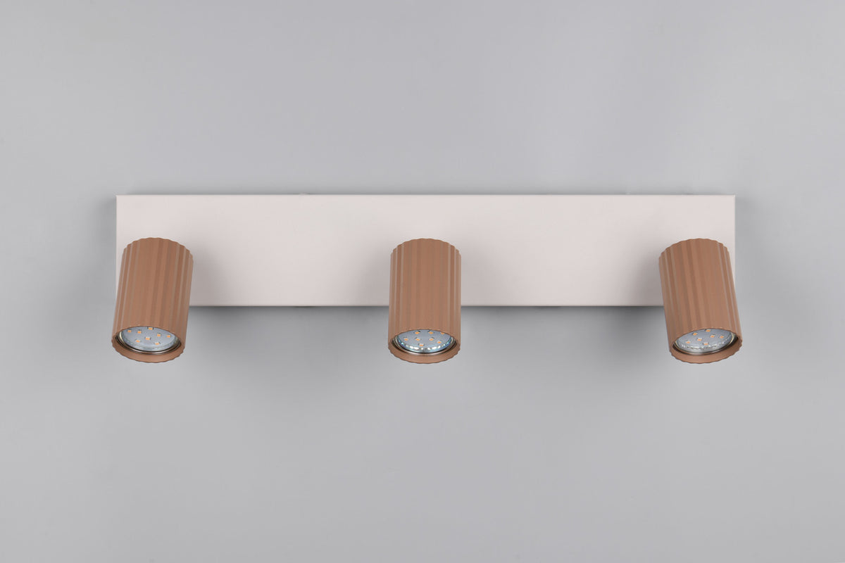 Vue de dessous montrant les trois modules LED dans les têtes cylindriques cannelées.