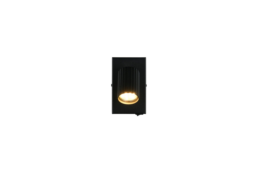 Vue de face du spot noir, plaque rectangulaire et cylindre lumineux central.
