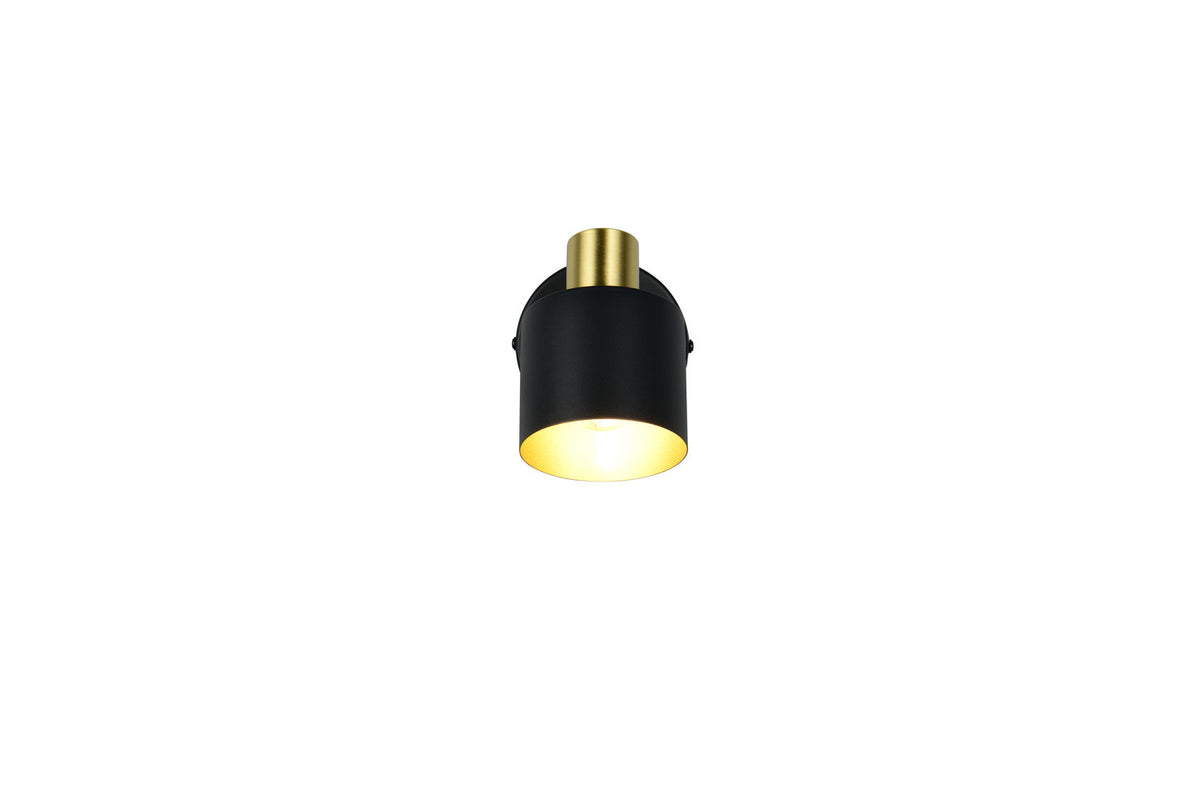 Gros plan sur la tête cylindrique noire et dorée, lumière chaude allumée.