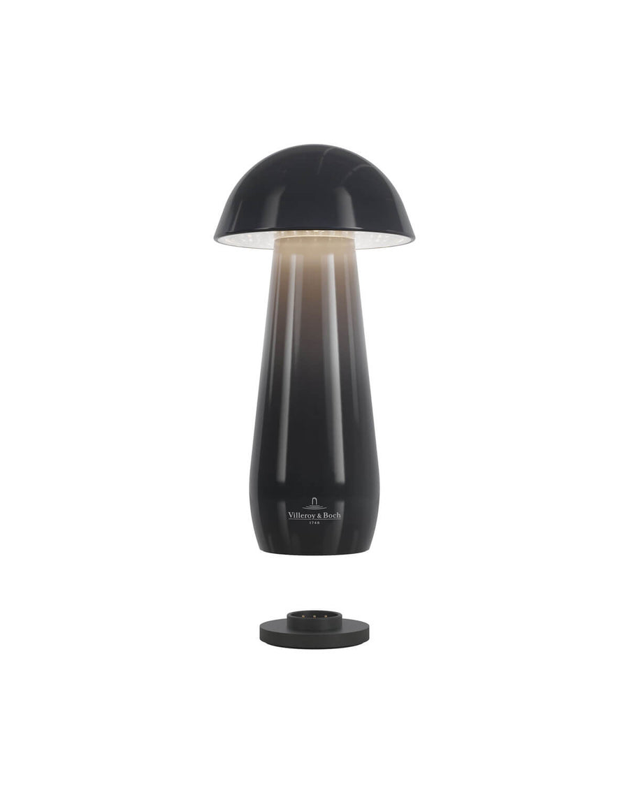 Lampe sans fil détachée de sa base ronde, montrant le socle de recharge