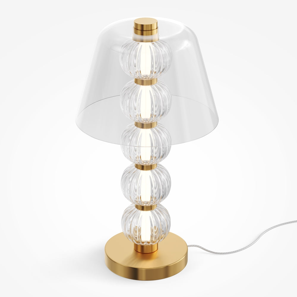Vue de trois quarts du luminaire allumé révélant la transparence du verre